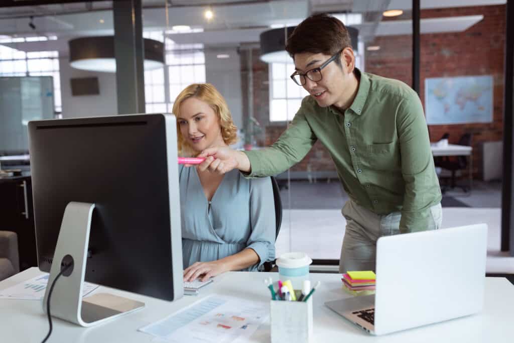 Healthcare technology professionals pointing to computer monitor