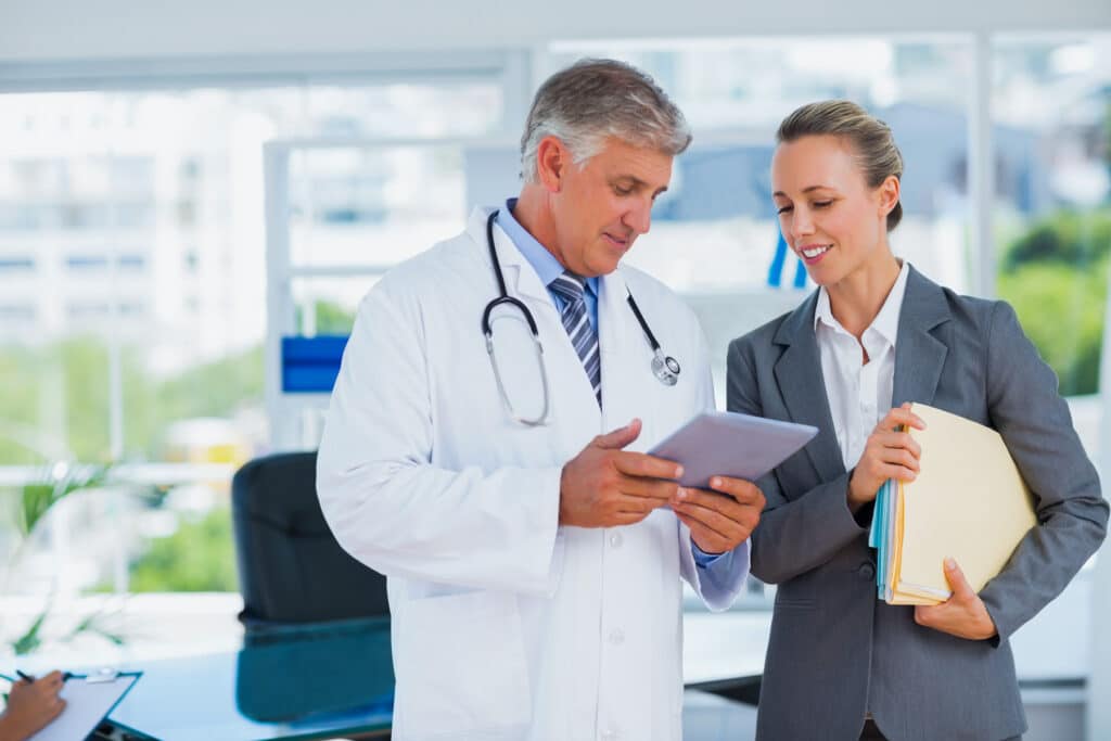 Confident doctor and pretty businesswoman discussing