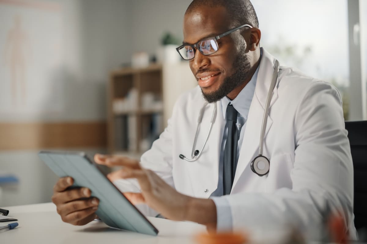 A healthcare provider reviews patient data, reflecting Centene's unified member view approach.