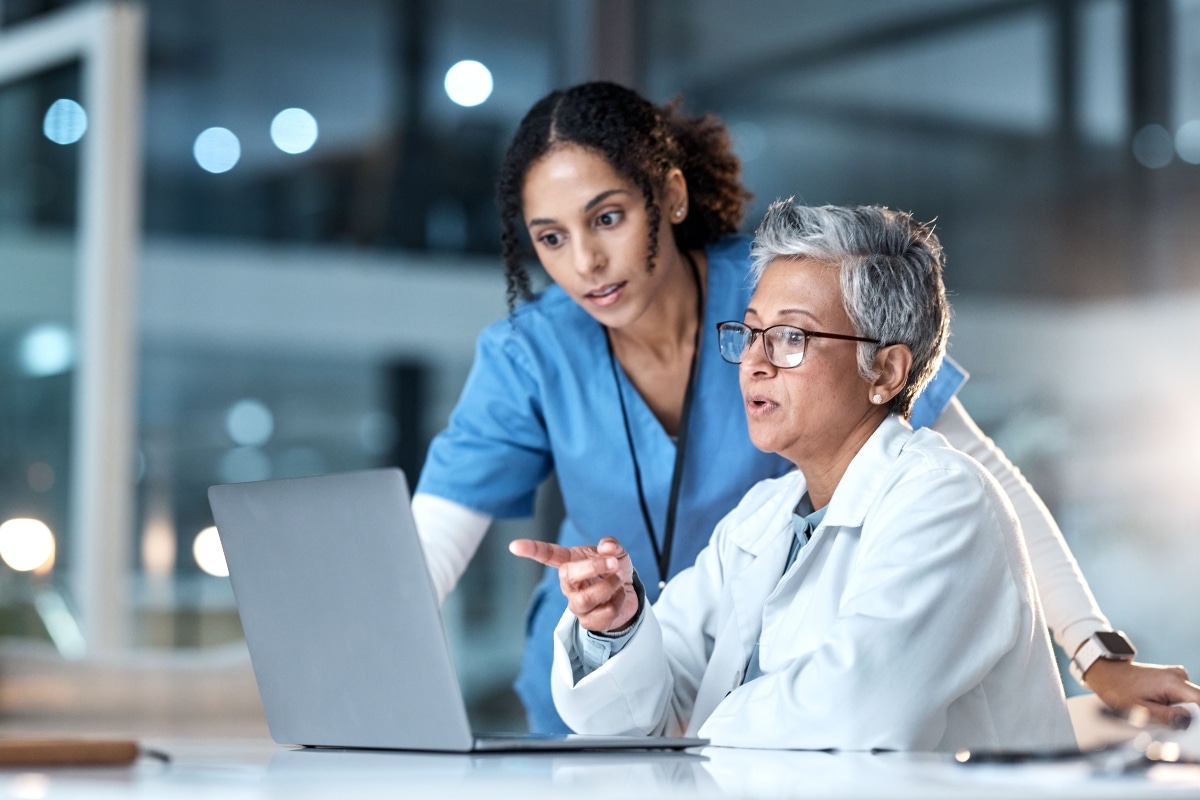 A care team analyzes patient data challenges tied to multi-system EHR integration.