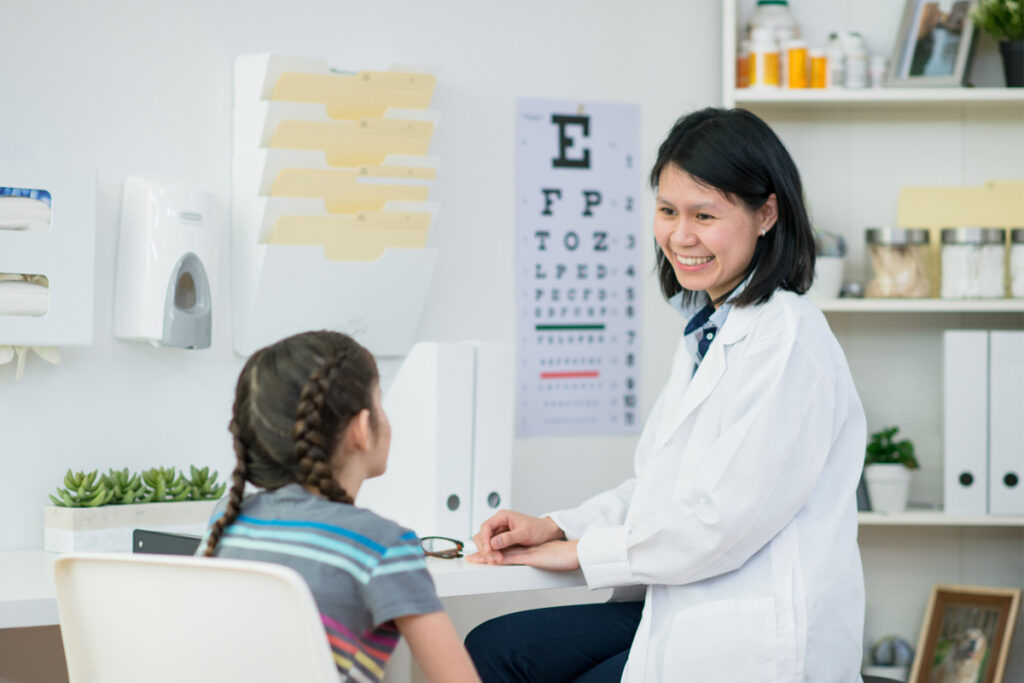 A patient fills out a paper form with a nurse, showing a chance to improve patient experience.