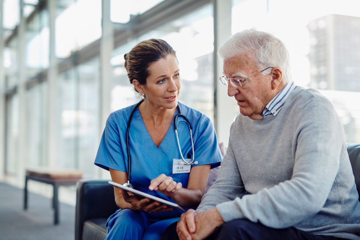 Physician consults with her patient as AI frees up time for focused, human care.