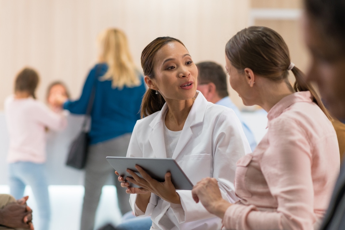 Doctor discusses care with patient, illustrating accurate provider data improving access and trust.