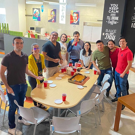 Verato team members share a company lunch together in a bright, casual space.