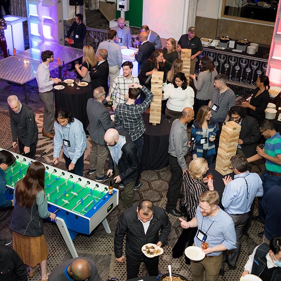 Verato employees enjoy foosball and games together at a team-focused company event.