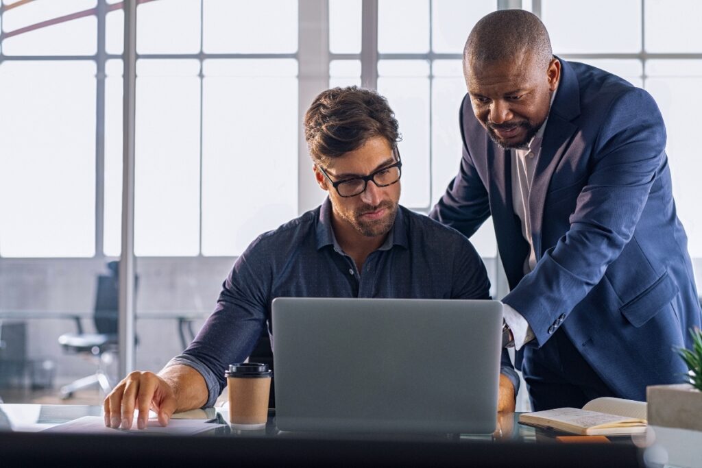 Two colleagues collaborate on integrating data across connected systems.