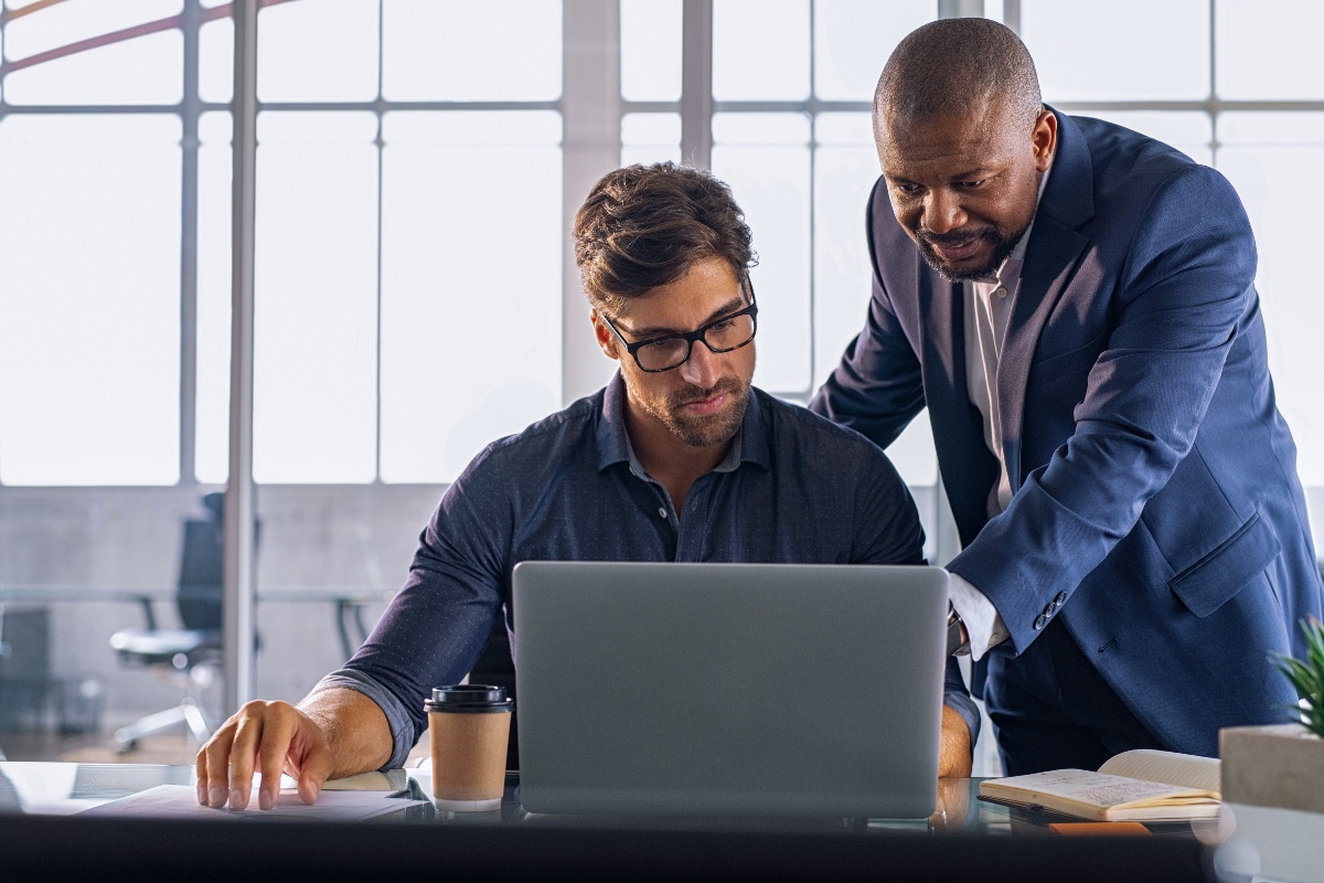 Two colleagues collaborate on integrating data across connected systems.