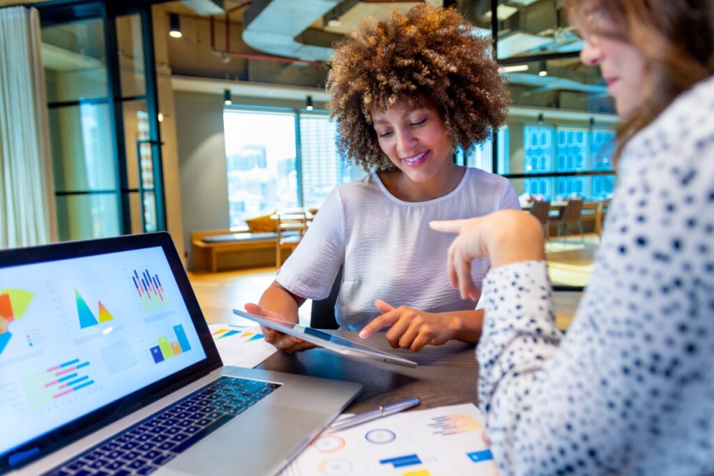 Colleagues review population health analytics tied to one organization record.