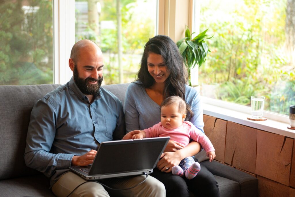 A household reviews a personalized offer together on a laptop.