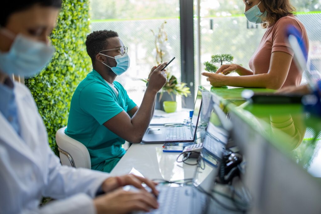 A healthcare provider checks in a patient, using patient matching to ensure accurate billing.